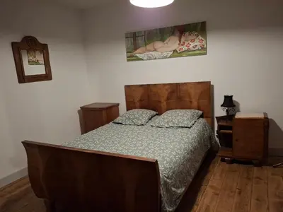 Un ou plusieurs lits dans un hébergement de l'établissement Charmante maison au coeur du Beaujolais