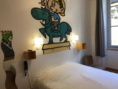 Un ou plusieurs lits dans un hébergement de l'établissement Hôtel Le Boulevardier