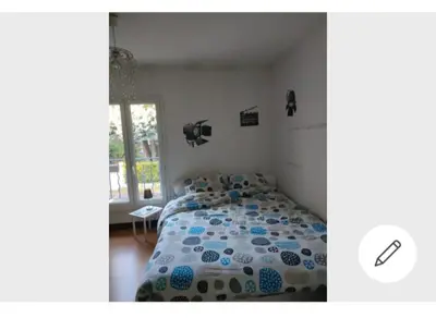 Un ou plusieurs lits dans un hébergement de l'établissement Chambre souriante