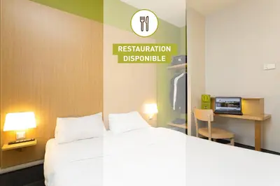 Un ou plusieurs lits dans un hébergement de l'établissement B&B HOTEL Lyon Sud États-Unis