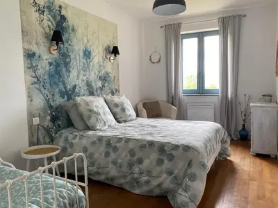 Un ou plusieurs lits dans un hébergement de l'établissement Maison sur cour et véranda
