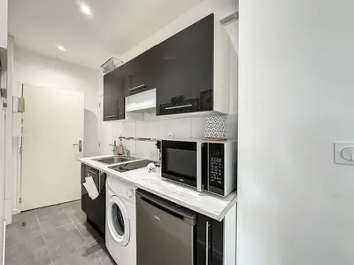 Cuisine ou kitchenette dans l'établissement Cosy appart Perrin 1