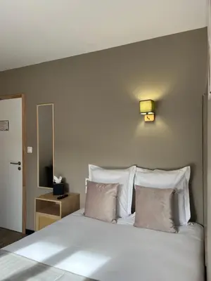Un ou plusieurs lits dans un hébergement de l'établissement Hôtel Comme chez soi