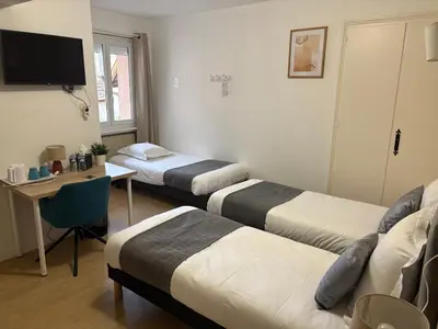 Un ou plusieurs lits dans un hébergement de l'établissement Hôtel Comme chez soi