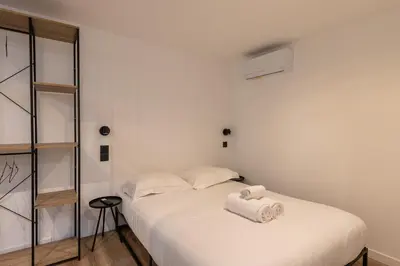 Un ou plusieurs lits dans un hébergement de l'établissement SmartStay Bird Family - Lyon