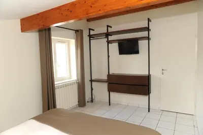 Un ou plusieurs lits dans un hébergement de l'établissement A la Suite du Jardin de l'Isle