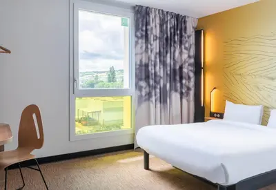Un ou plusieurs lits dans un hébergement de l'établissement B&B HOTEL Villefranche-sur-Saône Sud