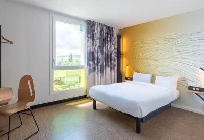 Un ou plusieurs lits dans un hébergement de l'établissement B&B HOTEL Villefranche-sur-Saône Sud