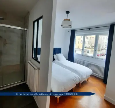 Un ou plusieurs lits dans un hébergement de l'établissement Guillaume Cityscape