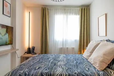 Un ou plusieurs lits dans un hébergement de l'établissement Villeurbanne Centre Appartement Meublé