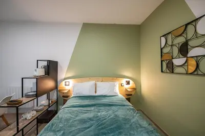 Un ou plusieurs lits dans un hébergement de l'établissement Suite Kella Tassin - Beau studio rénové