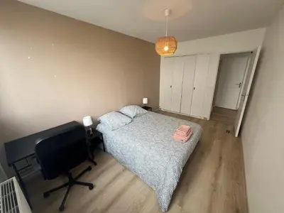 Un ou plusieurs lits dans un hébergement de l'établissement Appartement 6-8 personnes, accès direct à Lyon