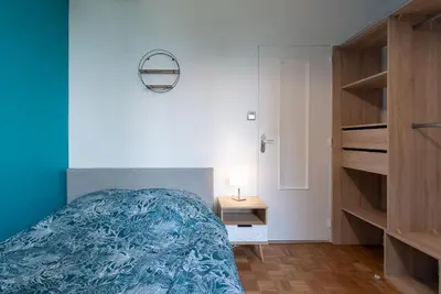 Un ou plusieurs lits dans un hébergement de l'établissement Appartement rénové pour 6 avec parking