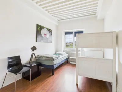 Un ou plusieurs lits dans un hébergement de l'établissement Séjourner au Château de la Roue Grand appartement 160 m2