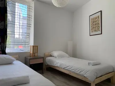 Un ou plusieurs lits dans un hébergement de l'établissement HOMEYPIC T3 en rez de jardin proche de Lyon