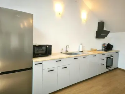 Cuisine ou kitchenette dans l'établissement Les Tilleuls - cnpe bugey - bases de loisirs - pérouges
