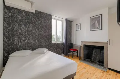 Un ou plusieurs lits dans un hébergement de l'établissement Le Hamburg - Les appartements de l'olivier