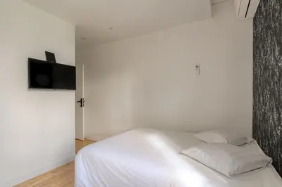 Un ou plusieurs lits dans un hébergement de l'établissement Le Hamburg - Les appartements de l'olivier