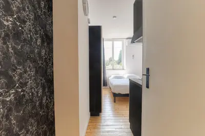 Un ou plusieurs lits dans un hébergement de l'établissement Le Berlin - Les appartements de l'olivier