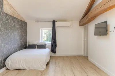 Un ou plusieurs lits dans un hébergement de l'établissement Le Düsseldorf - Les appartements de l'olivier