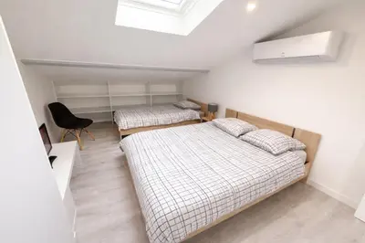 Un ou plusieurs lits dans un hébergement de l'établissement Duplex 2 chambres Meximieux centre ville
