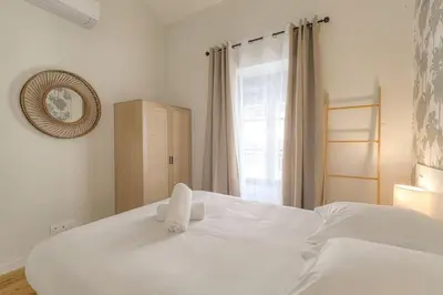 Un ou plusieurs lits dans un hébergement de l'établissement Appartement T3 neuf, climatisé proche Lyon 3