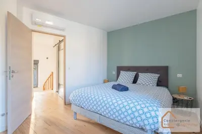 Un ou plusieurs lits dans un hébergement de l'établissement Confort Nature - Maisonnette avec Jardin, Garage, Proche Eurexpo