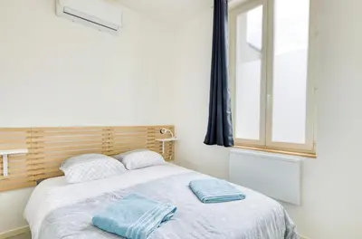 Un ou plusieurs lits dans un hébergement de l'établissement Appartement T2 moderne cosy et climatisé à proximité du centre ville de lyon