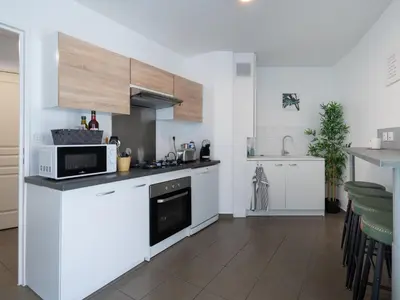Cuisine ou kitchenette dans l'établissement L'Arlequin Familial et Reposant