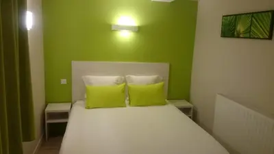 Un ou plusieurs lits dans un hébergement de l'établissement Hôtel Restaurant Carpe Diem