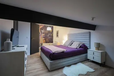 Un ou plusieurs lits dans un hébergement de l'établissement Mi Amore- Gîte 3 suites près de Lyon, parking free