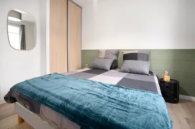 Un ou plusieurs lits dans un hébergement de l'établissement L'Abri Citadin - Deux chambres