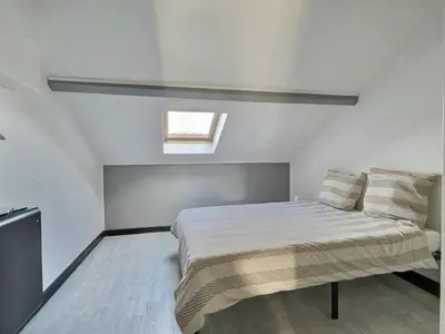 Un ou plusieurs lits dans un hébergement de l'établissement Appartement 3 chambres proche gare