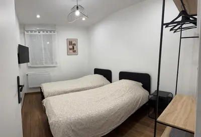 Un ou plusieurs lits dans un hébergement de l'établissement joli appartement T4