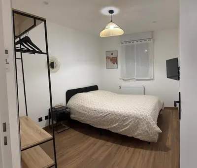 Un ou plusieurs lits dans un hébergement de l'établissement joli appartement T4