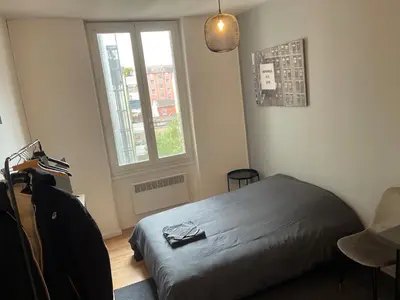 Un ou plusieurs lits dans un hébergement de l'établissement Studio Hôtel Villeurbanne Centre