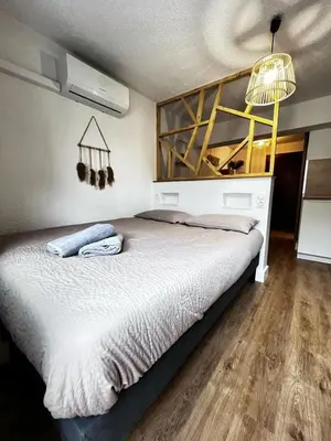 Un ou plusieurs lits dans un hébergement de l'établissement Studio le Cosy - Bourgoin Centre