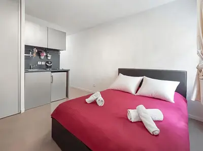 Un ou plusieurs lits dans un hébergement de l'établissement Studio Aux Portes de Lyon