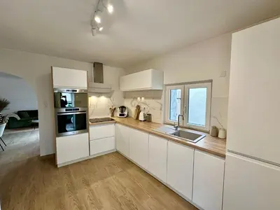 Cuisine ou kitchenette dans l'établissement La Petite Grange