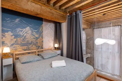 Un ou plusieurs lits dans un hébergement de l'établissement Appartement vue sur la Saône