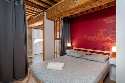 Un ou plusieurs lits dans un hébergement de l'établissement Appartement vue sur la Saône