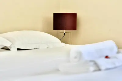 Un ou plusieurs lits dans un hébergement de l'établissement Appartement chaleureux Parking privé