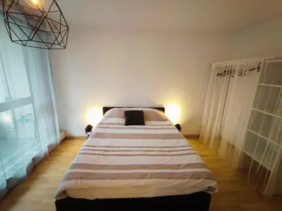 Un ou plusieurs lits dans un hébergement de l'établissement Grand T2 central, balcons sur parc