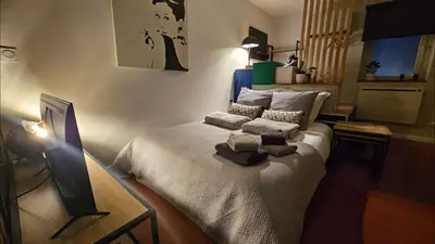 Un ou plusieurs lits dans un hébergement de l'établissement Chez Auguste - charmant studio 3 étoiles