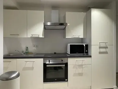 Cuisine ou kitchenette dans l'établissement Un charmant appartement bien équipé