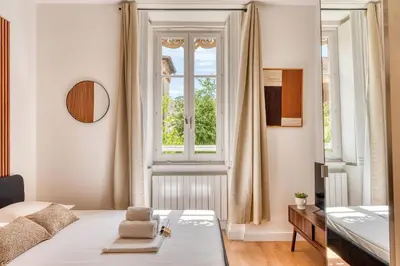 Un ou plusieurs lits dans un hébergement de l'établissement Le Dock Lodge - Studio - proche quai de Saone