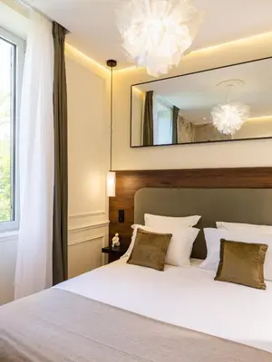 Un ou plusieurs lits dans un hébergement de l'établissement Hausman Suites - Appart Hotel
