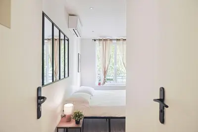 Un ou plusieurs lits dans un hébergement de l'établissement LES BULLES DE MONA - Passion - Spa - Clim