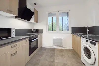 Cuisine ou kitchenette dans l'établissement Appartement Avec Balcon & Jardin