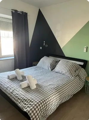 Un ou plusieurs lits dans un hébergement de l'établissement Spacieux appartement idéal séjour pro famille